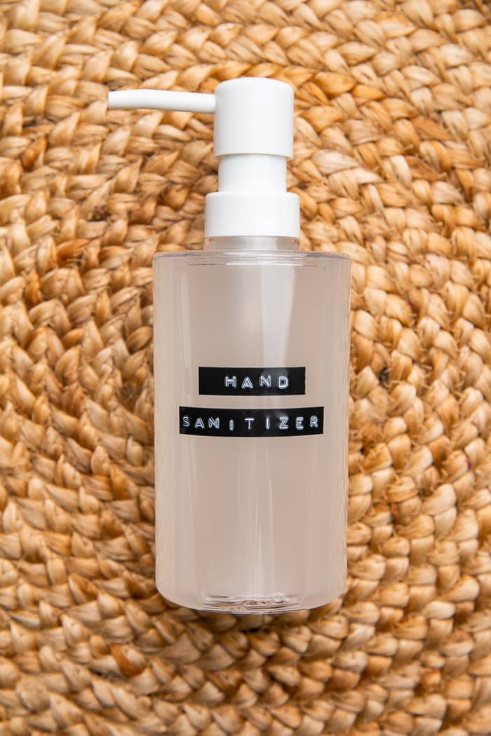 Bottle of DIY hand sanitizer on woven mat