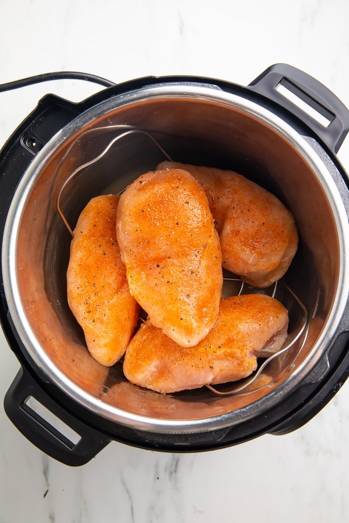 frozen, seasoned chicken breasts in an instant pot before cooking