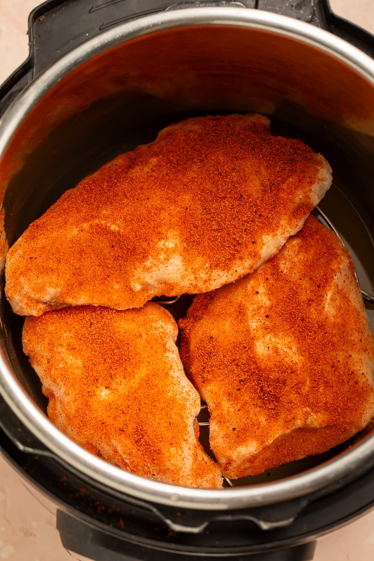 Frozen seasoned chicken breasts in an instant pot.
