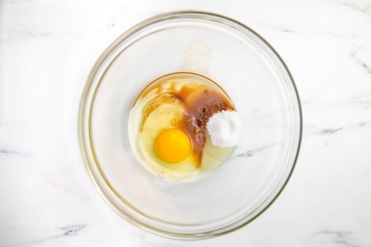 Large egg, coconut sugar, baking powder, and salt in a large glass mixing bowl.