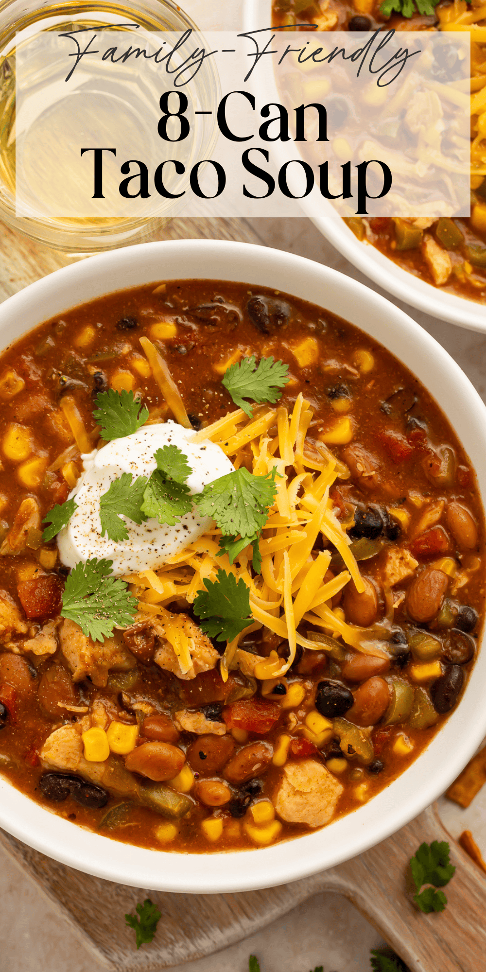 Homemade taco soup with black beans, kidney beans, corn, and chicken in white serving bowl
