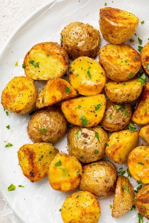 Roasted potatoes on a white platter