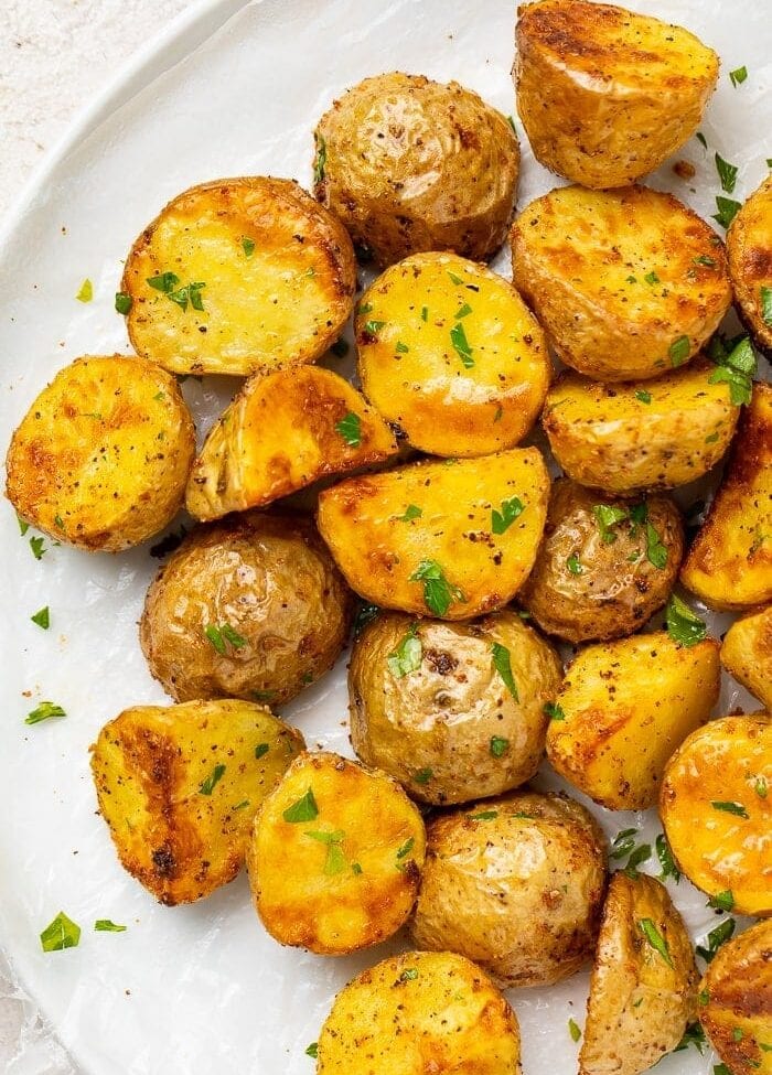 Roasted potatoes on a white platter