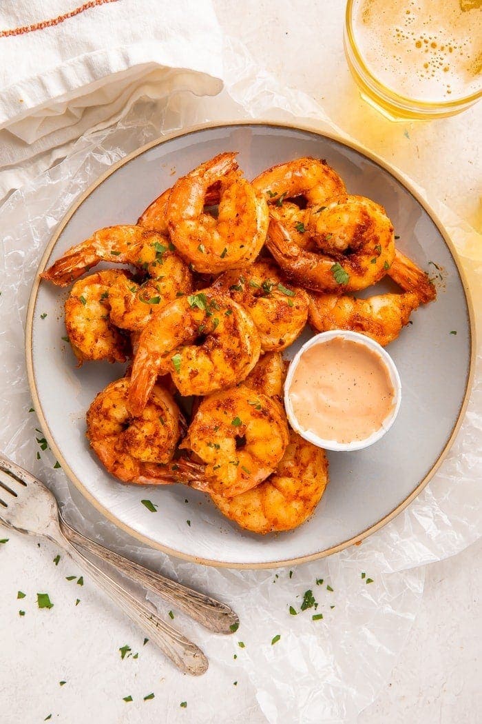 Plate of air fryer shrimp with comeback sauce in a cup