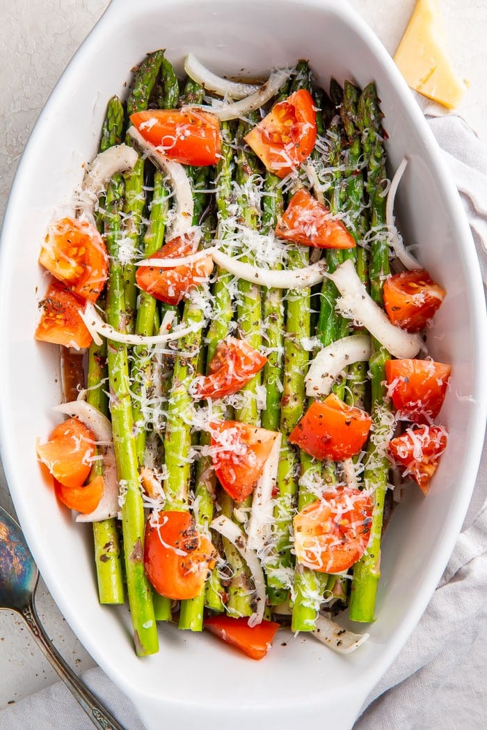 Asparagus salad in a serving dish with a spoon