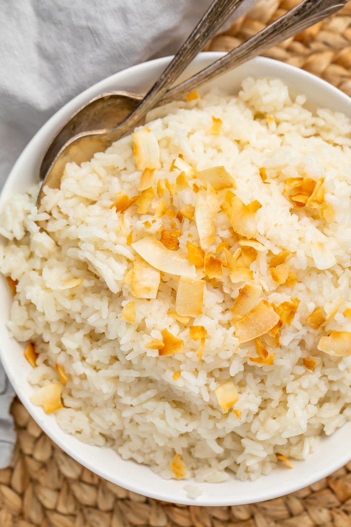 Bowl of coconut rice with two spoons in it
