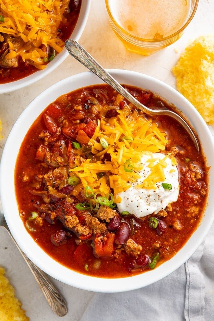 Instant Pot turkey chili in a bowl garnished with cheese and sour cream