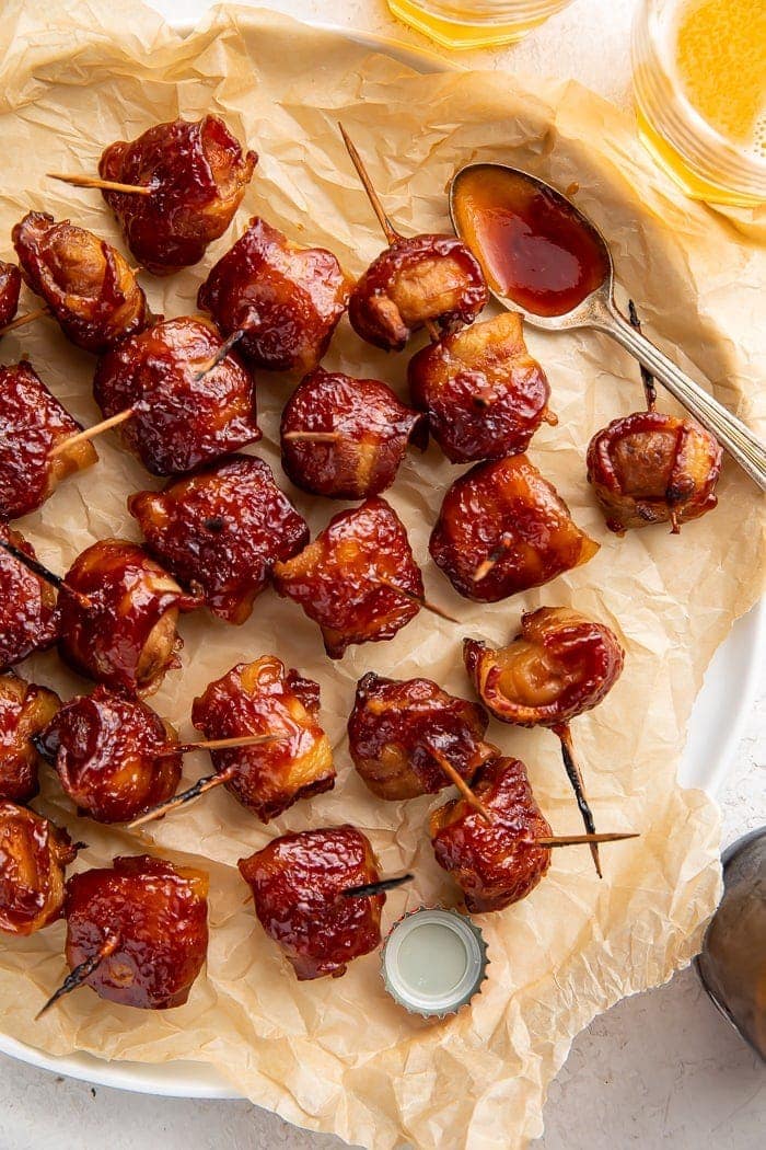 Bacon wrapped water chestnuts on a piece of parchment paper