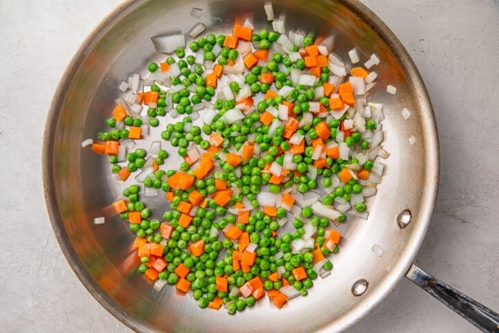 Mixed vegetables in a large silver skillet.