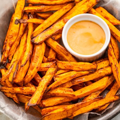 A bowl of homemade air fryer sweet potato fries on a table.
