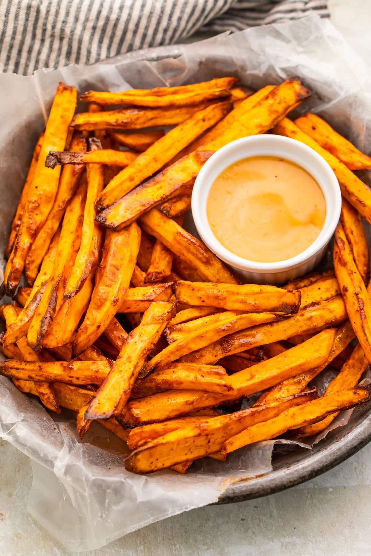 A bowl of homemade air fryer sweet potato fries on a table.