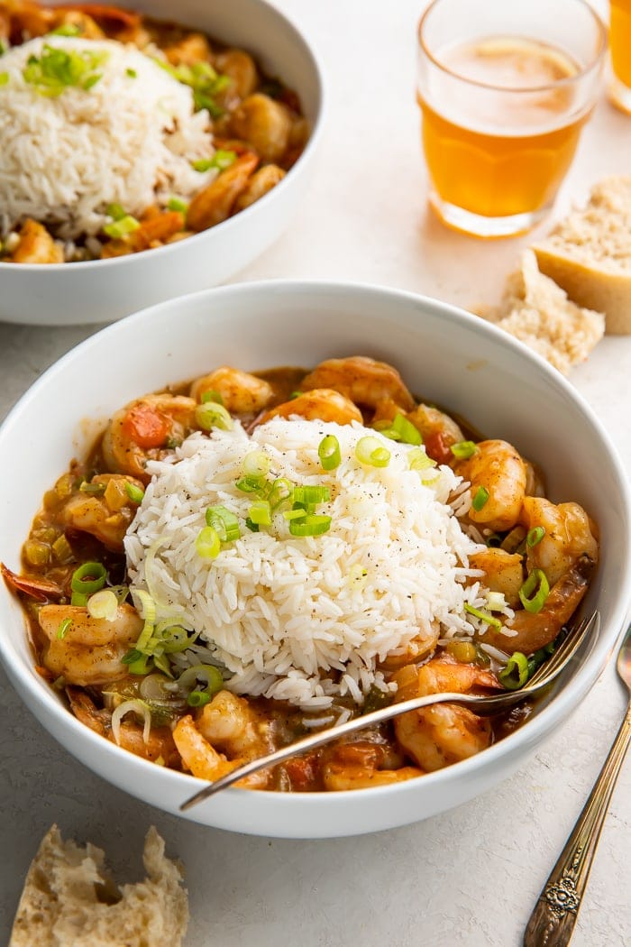 A bowl of shrimp etouffee with a spoon in it