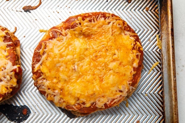 A cooked Taco Bell Mexican pizza with melted cheese sitting on top of a baking sheet