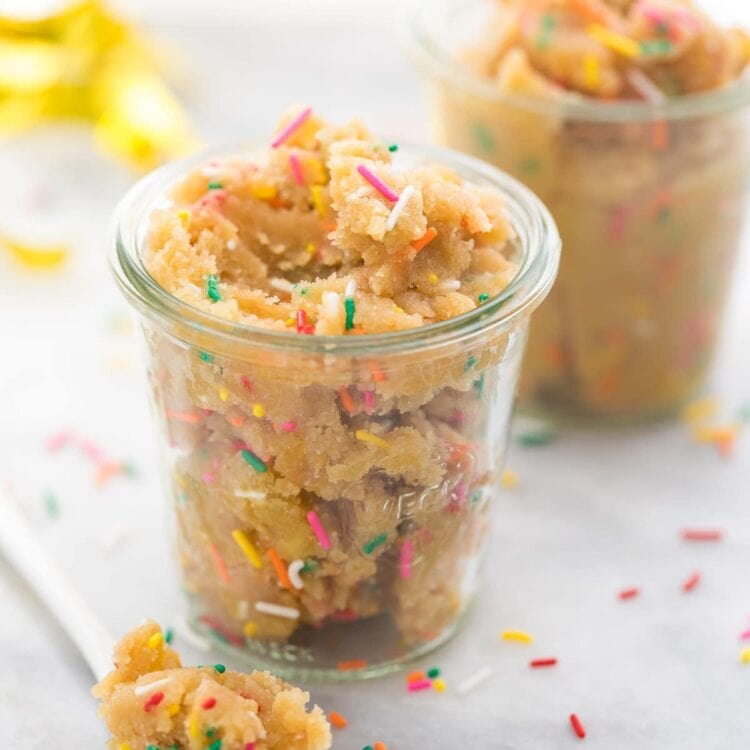 Birthday cake cookie dough in a glass cup