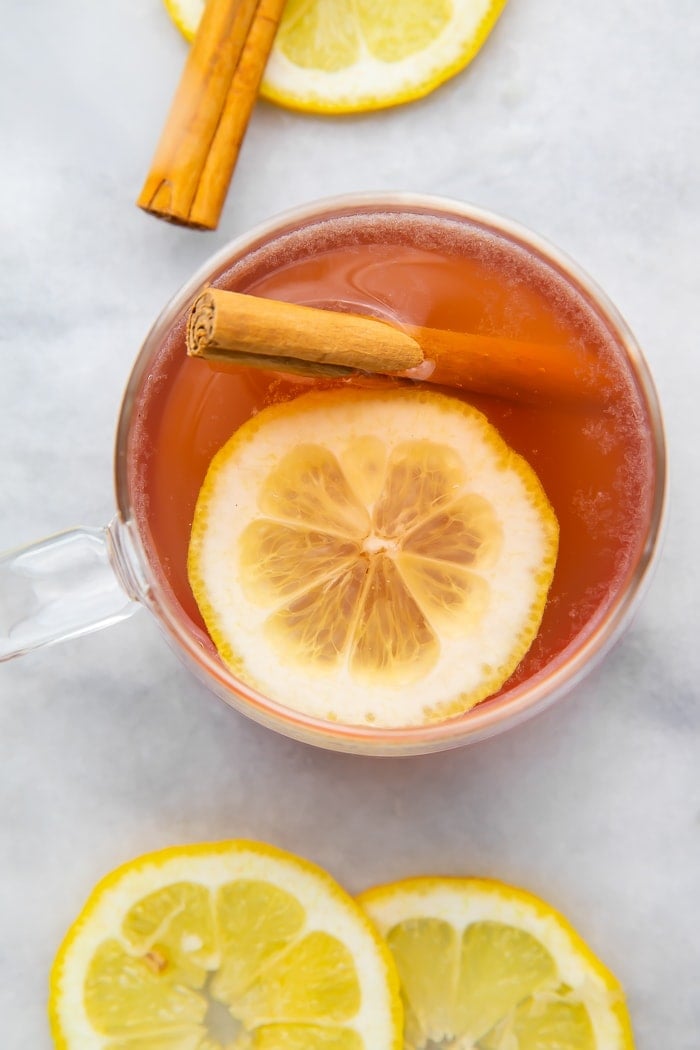 Overhead shot of elderberry hot toddy with lemon and cinnamon stick
