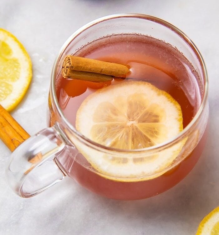 Overhead shot of elderberry hot toddy with lemon and cinnamon stick