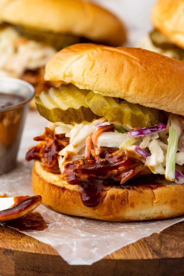 Sandwich with Instant Pot BBQ chicken topped with coleslaw