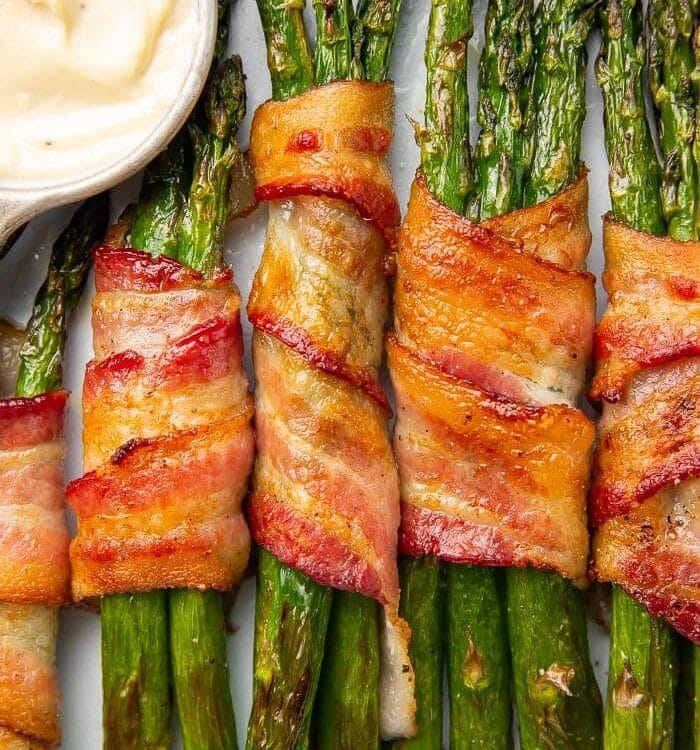 Bacon-wrapped asparagus stalks placed vertically in a row