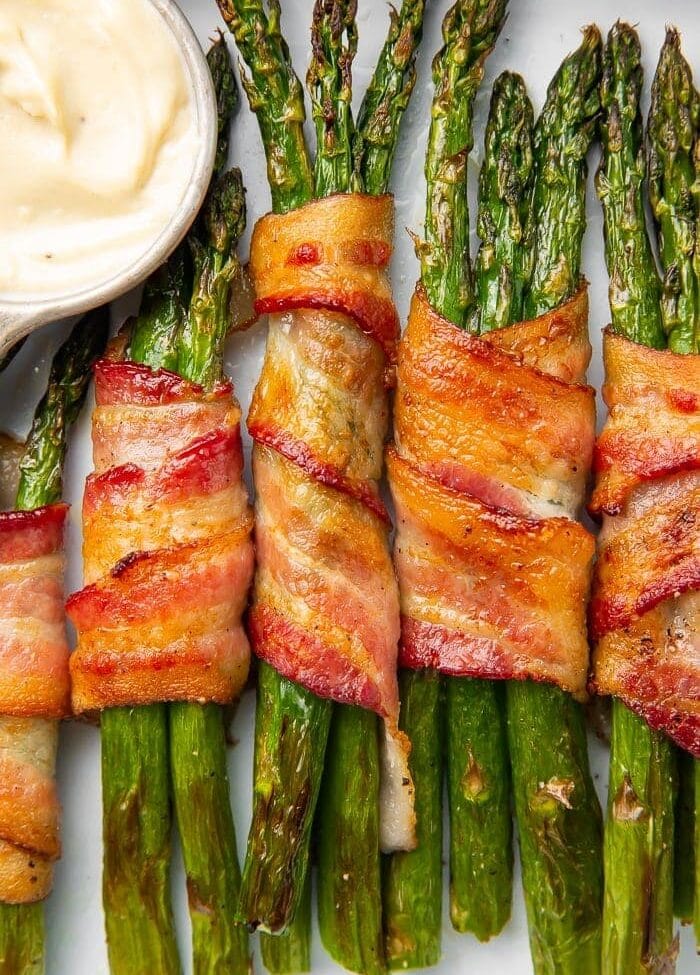 Bacon-wrapped asparagus stalks placed vertically in a row