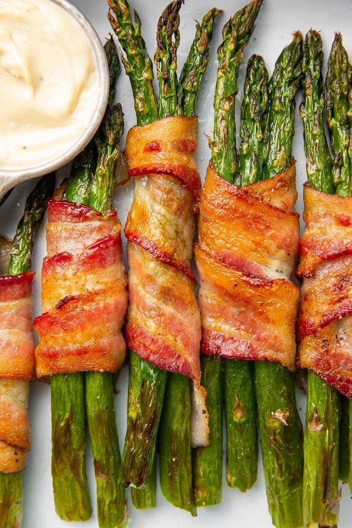 Bacon-wrapped asparagus stalks placed vertically in a row