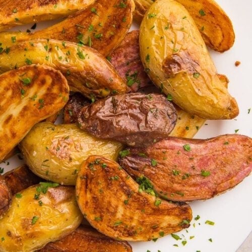 Roasted fingerling potatoes on a white plate