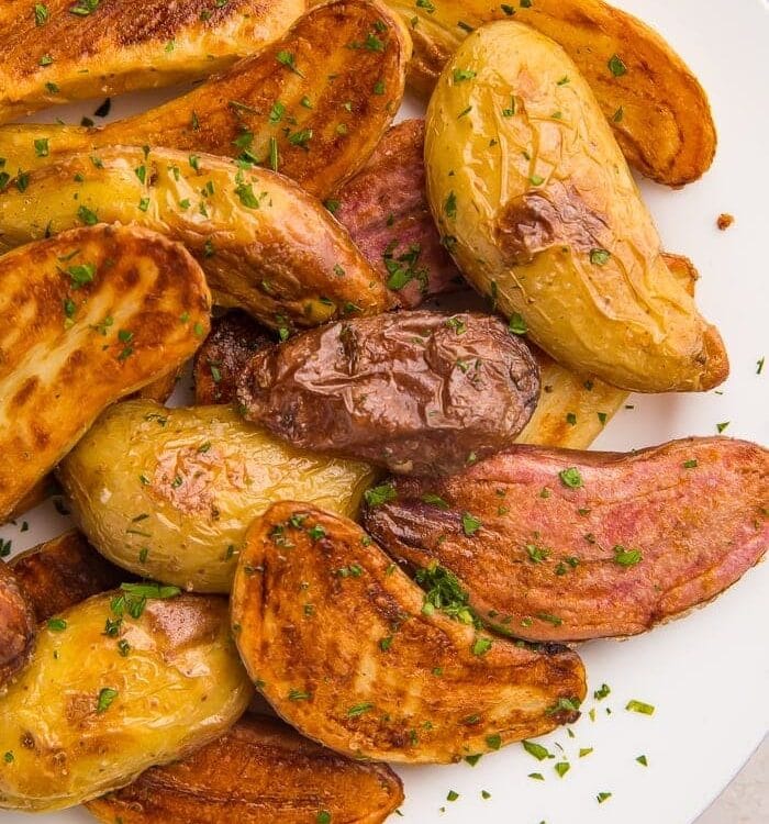 Roasted fingerling potatoes on a white plate