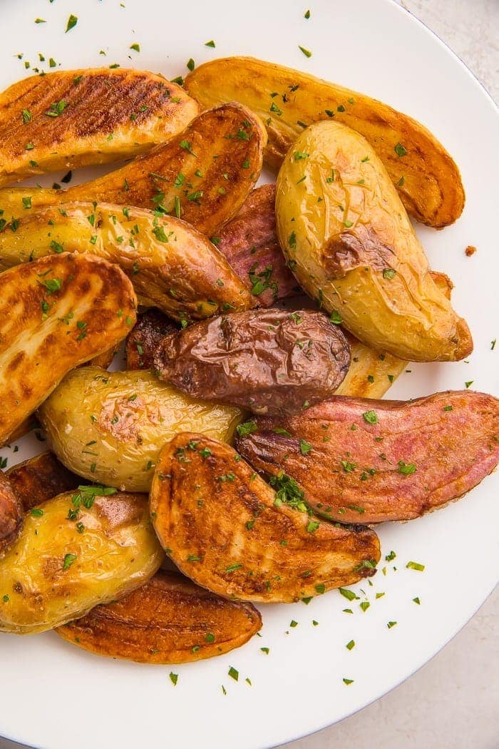 Roasted fingerling potatoes on a white plate