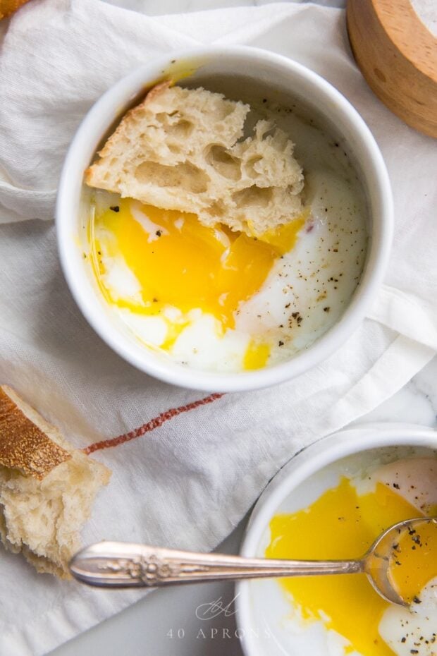 Sous vide eggs in ramekins on a marble counter top