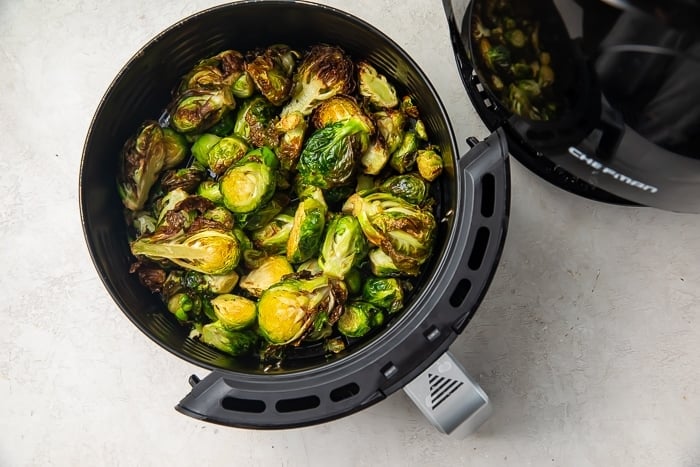 Fried brussels sprouts in air fryer basket