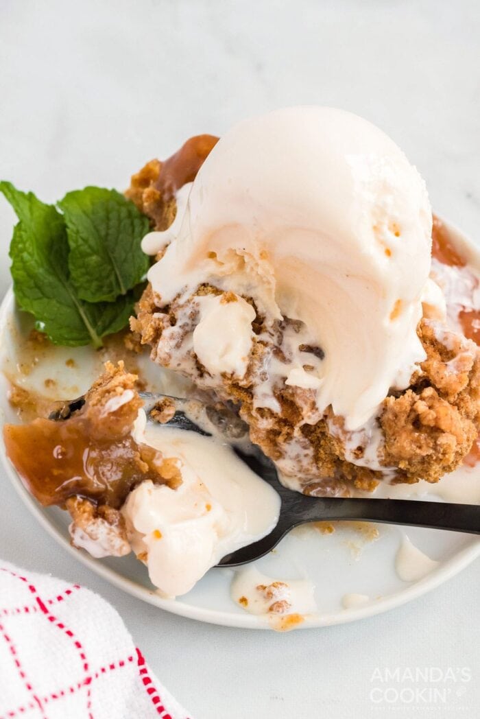 Vegetarian crock pot apple cobbler topped with vanilla ice cream