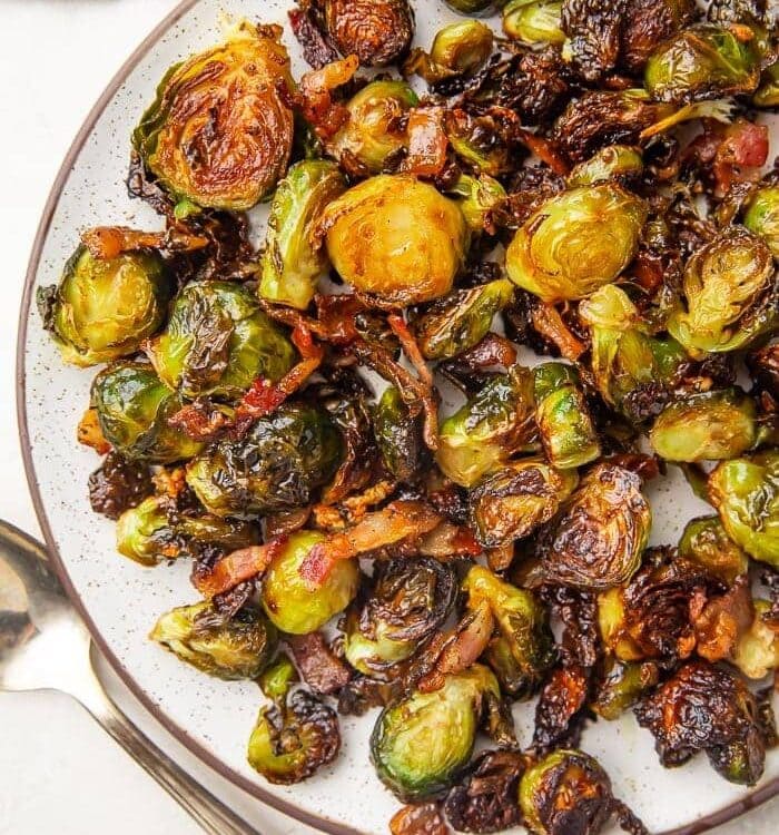 Lifestyle photo of a plate full of brussels sprouts and bacon