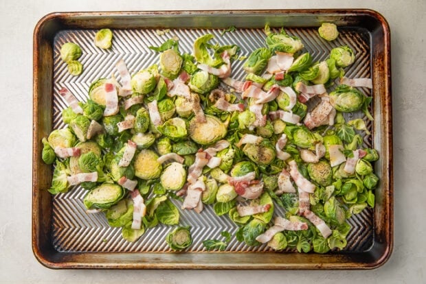 Silver sheet pan with brussels sprouts and bacon