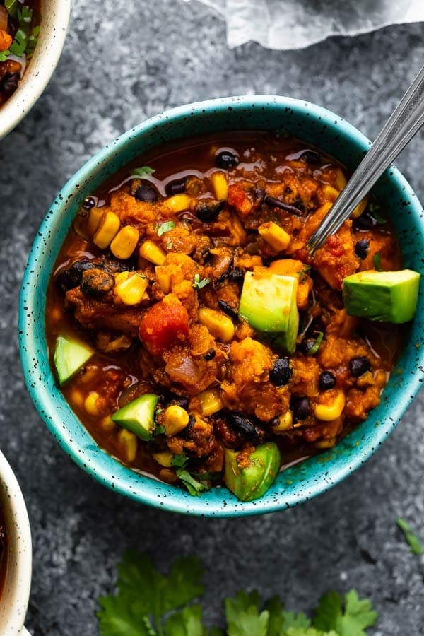Vegetarian Instant Pot chili in a turquoise bowl with a silver spoon