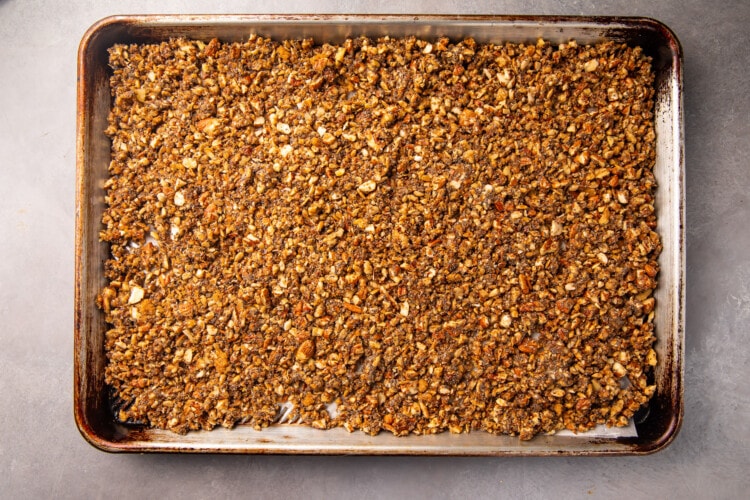 Unbaked keto granola spread out on a baking sheet