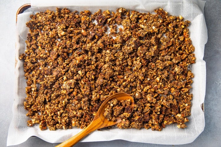 Baked keto granola on a sheet pan with parchment paper