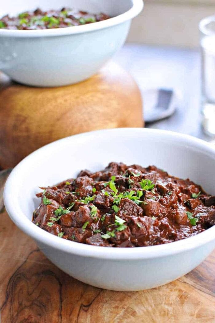 A white bowl of vegan slow cooker mole chili