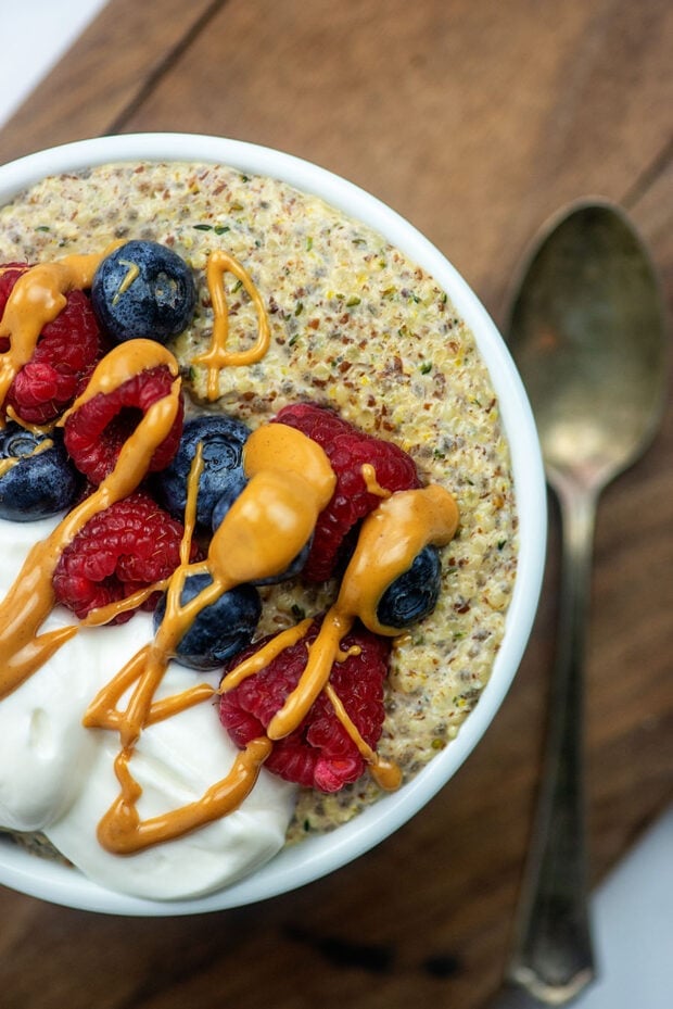 Keto oatmeal topped with fruit and whipped cream