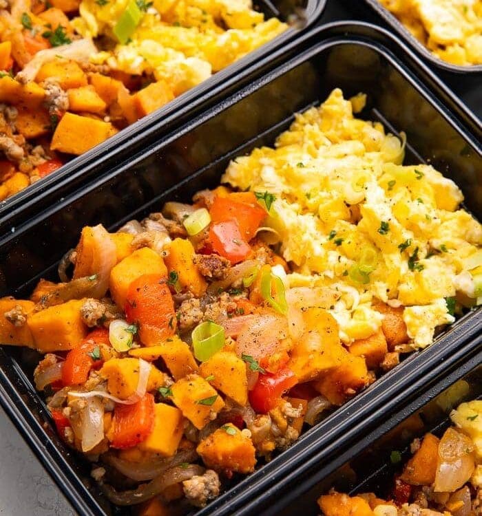 Reusable meal prep trays with sweet potato, scrambled eggs, and sausage for a whole30 breakfast