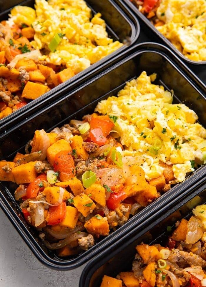 Reusable meal prep trays with sweet potato, scrambled eggs, and sausage for a whole30 breakfast