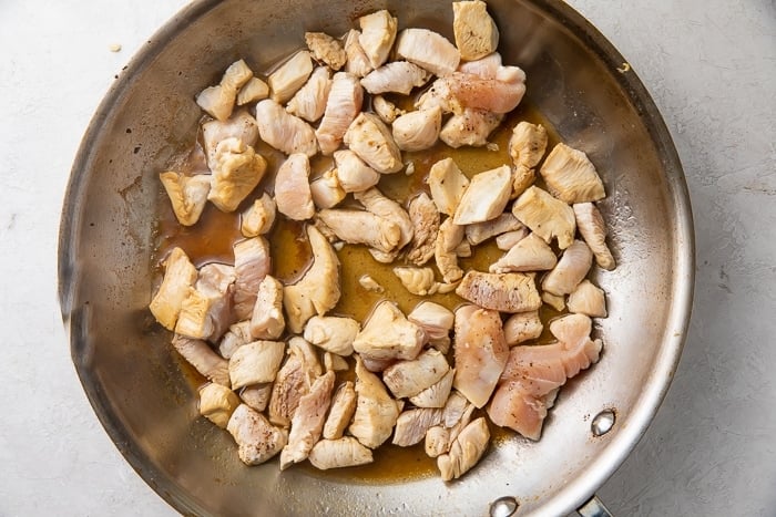 Chicken chunks sauteed in soy sauce in a large skillet