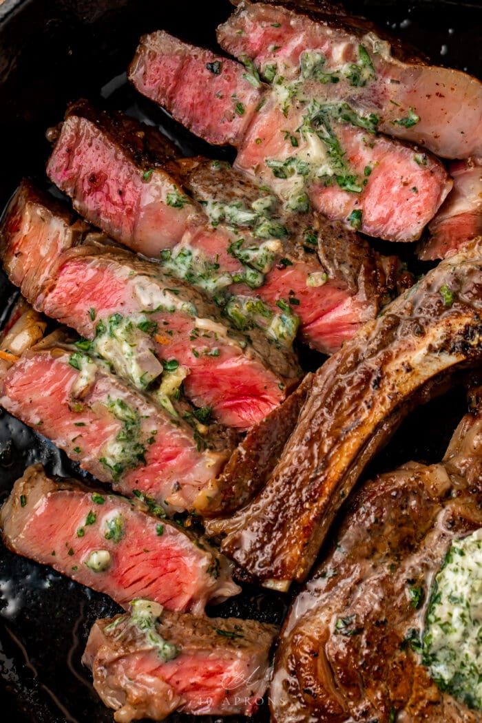 Cut medium-rare steak with garlic-herb butter melted on top
