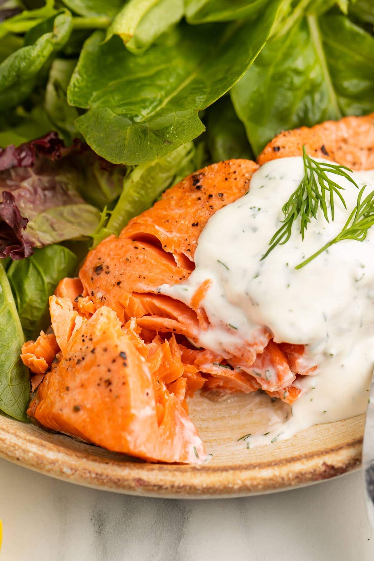 A tender air fryer salmon fillet, cut open to show the flaky meat.