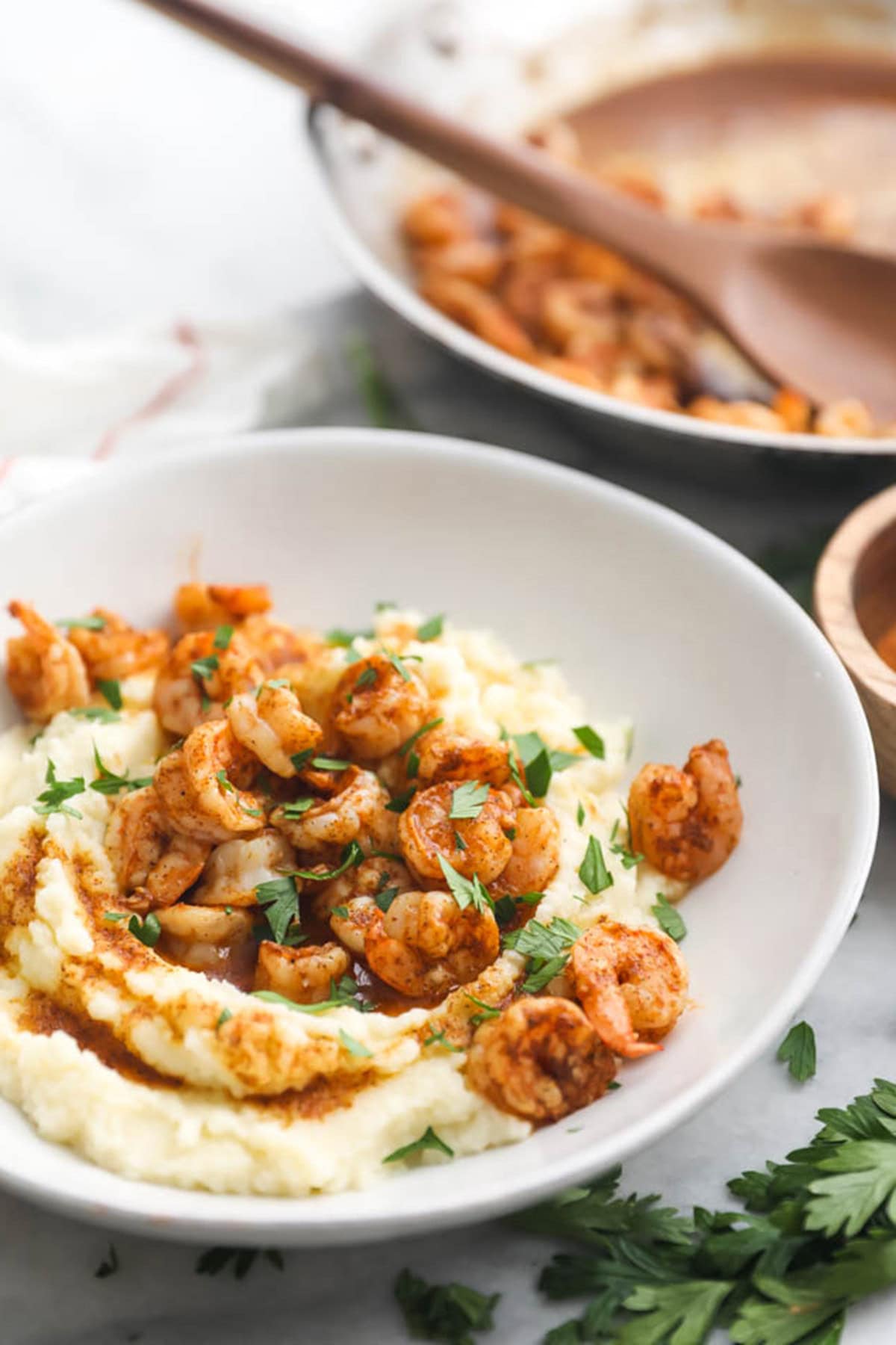 A bowl of paleo Cajun shrimp on a bed of cauliflower grits.