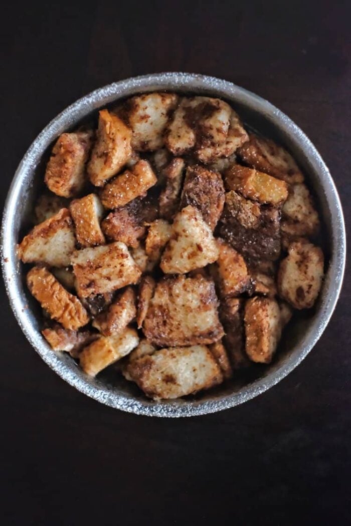 A bowl of French toast casserole on a dark background