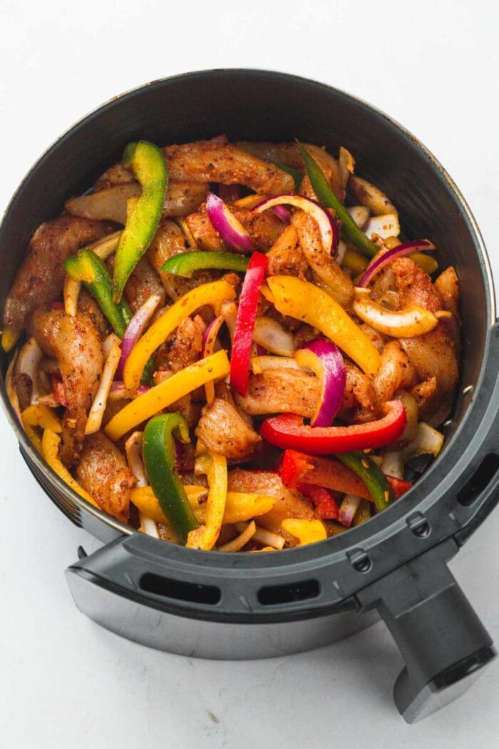 Keto chicken fajitas and peppers in an air fryer basket