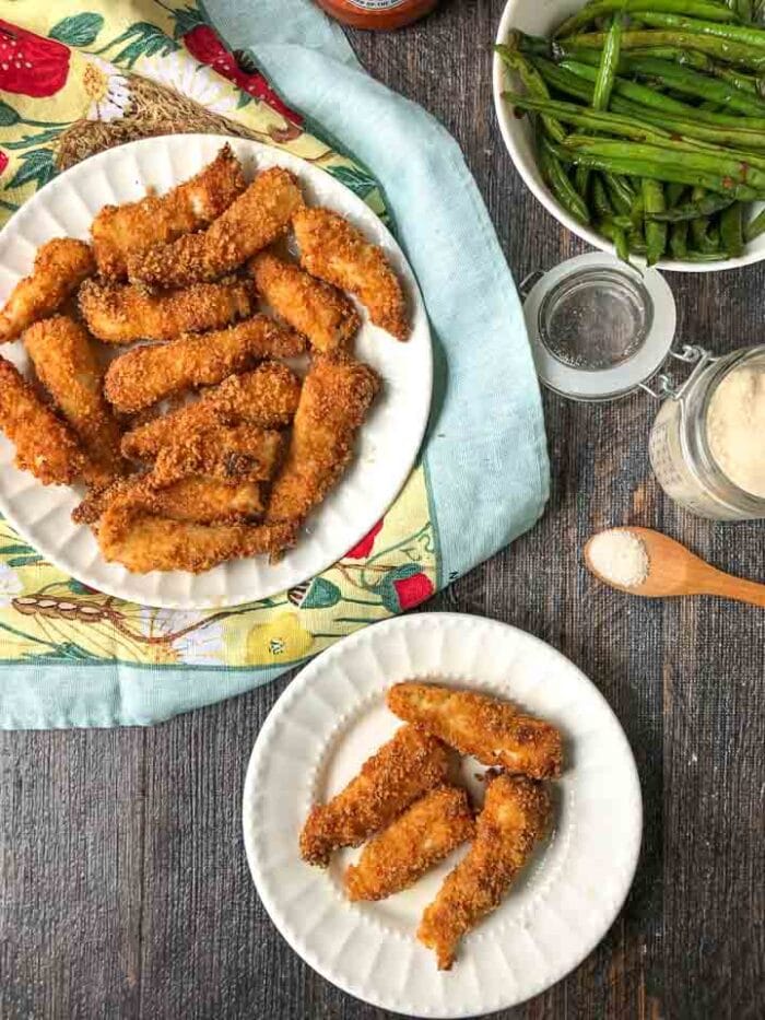 Two plates of air fried fishsticks 