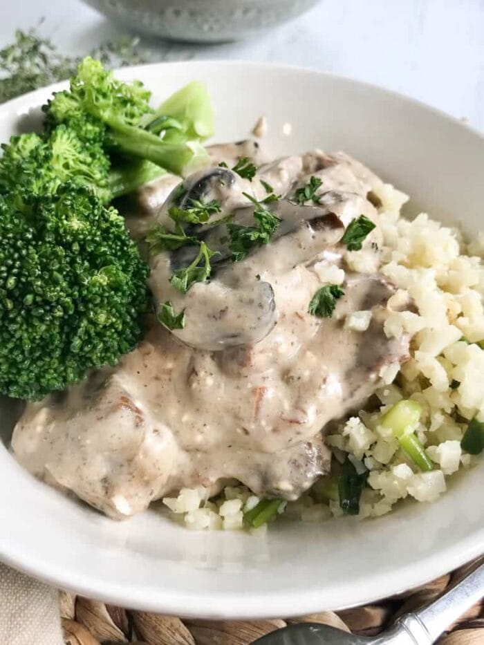 Keto beef stroganoff with broccoli in a white bowl