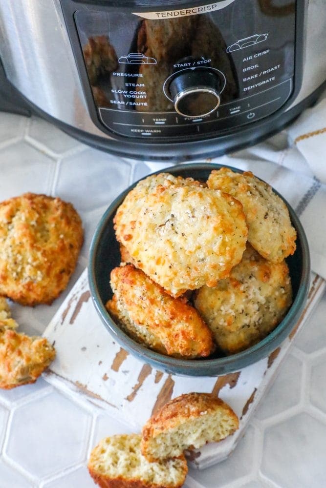 A bowl of keto rolls in front of an air fryer