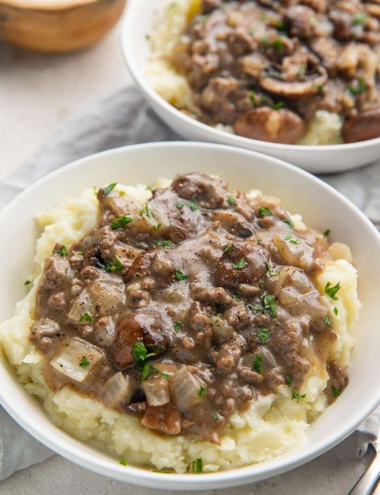 Plated whole30 beef stroganoff with mushroom gravy on top of mashed potatoes
