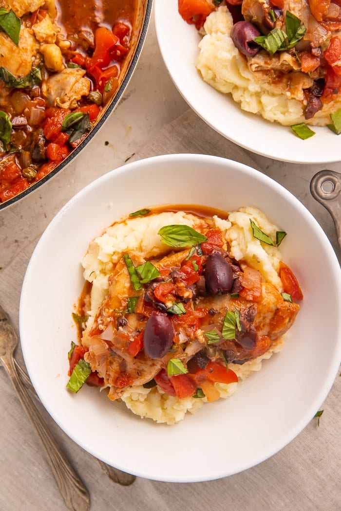 Plated Whole30 chicken cacciatore on top of mashed potatoes